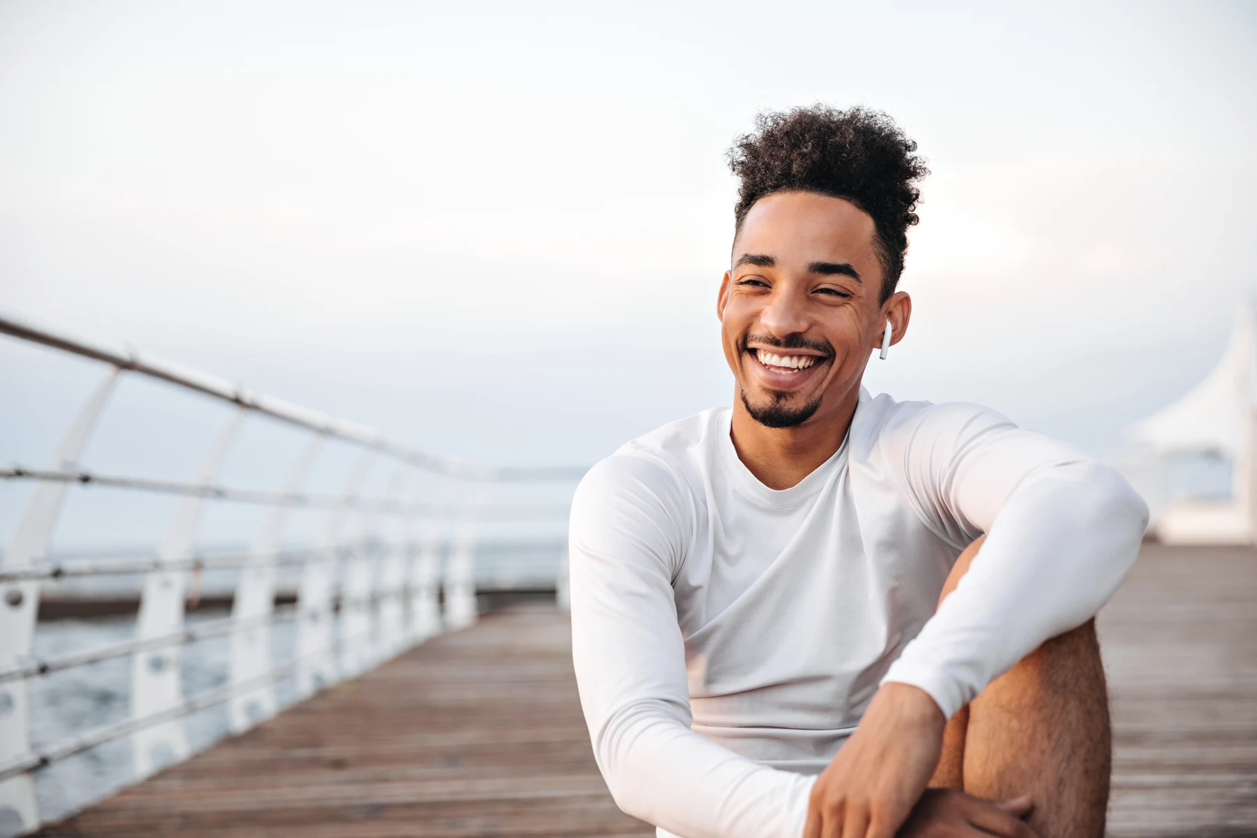 Smiling man sitting outdoors