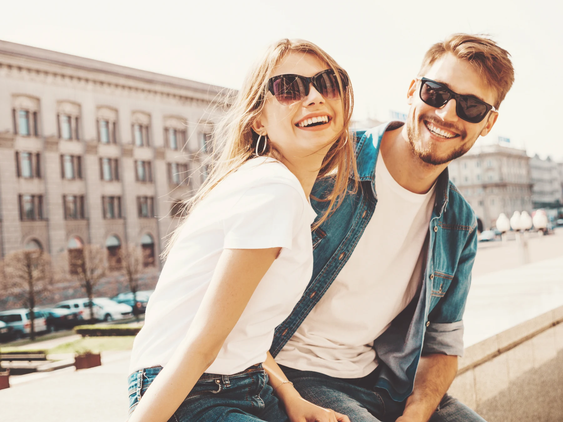 Smiling couple wearing sunglasses outdoors